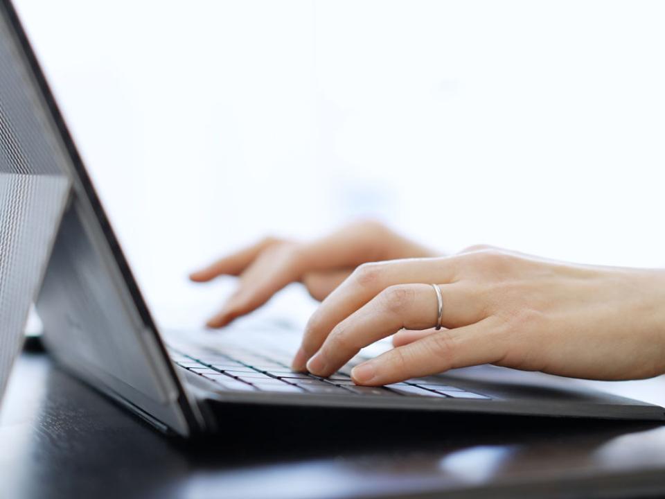 hands-of-a-woman-typing-on-a-laptop